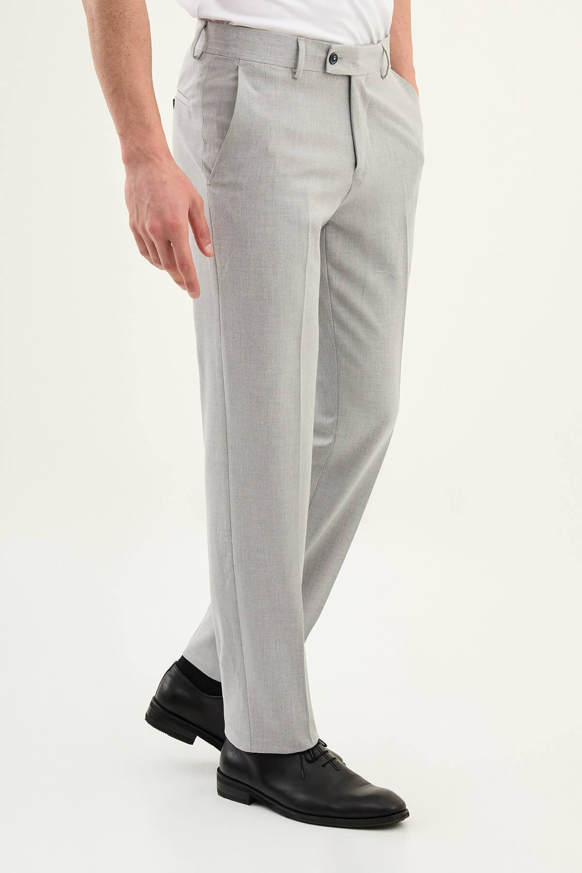 Gray slim-fit formal trousers with front pleats, styled with black leather shoes, ideal for summer office and semi-formal events.