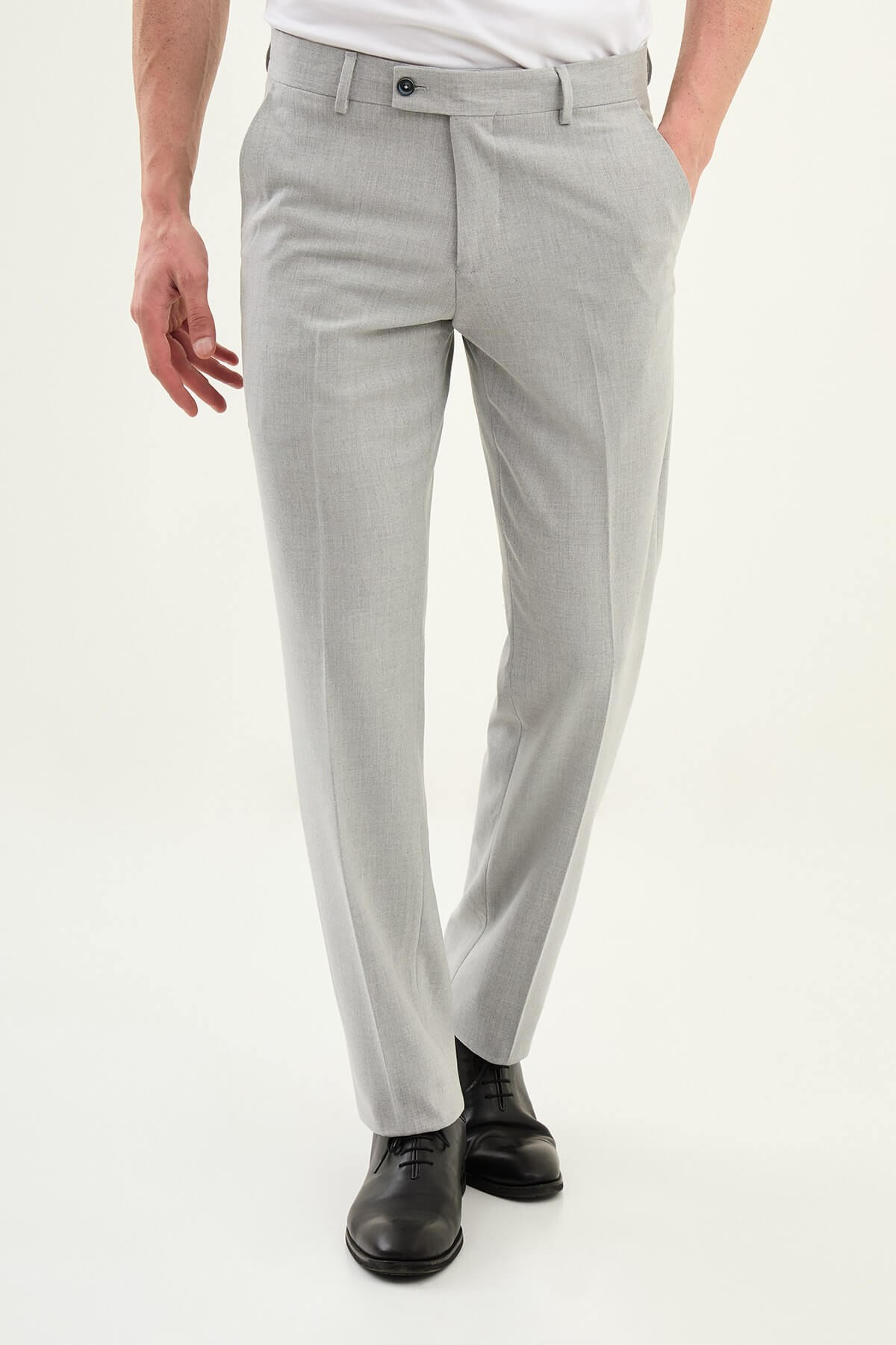 Gray slim-fit formal trousers with front pleats, styled with black leather shoes, ideal for summer office and semi-formal events.