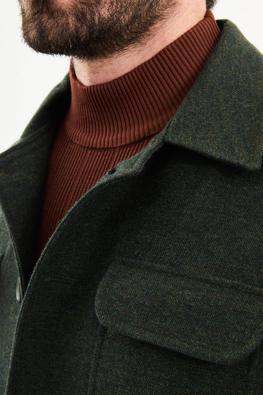 Men’s dark green wool blend utility jacket with button-up front and four pockets, regular fit smart casual layering jacket styled with beige trousers and brown turtleneck sweater