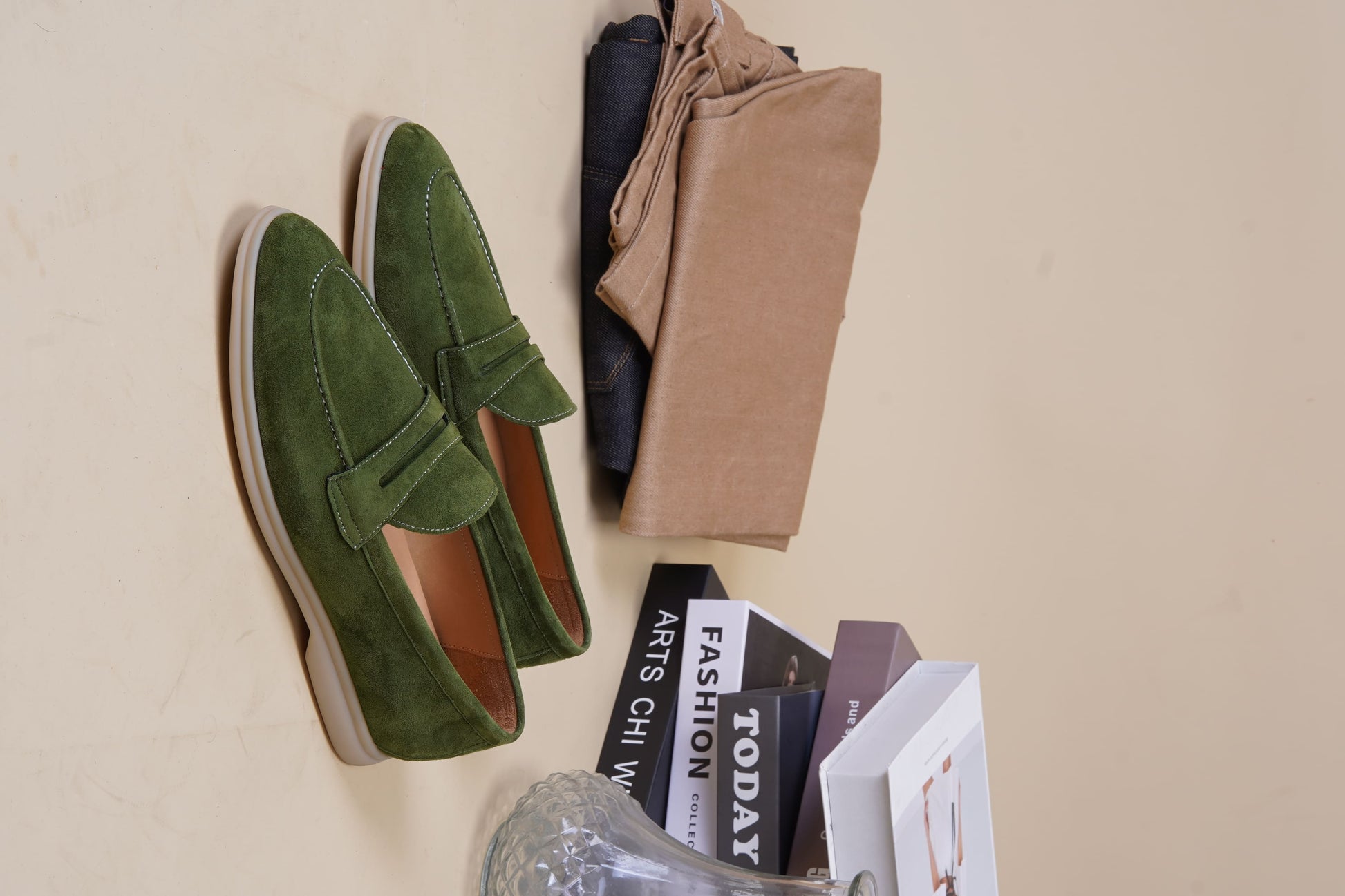 Men’s green suede leather penny loafers featuring classic vamp strap detail and lightweight sole.