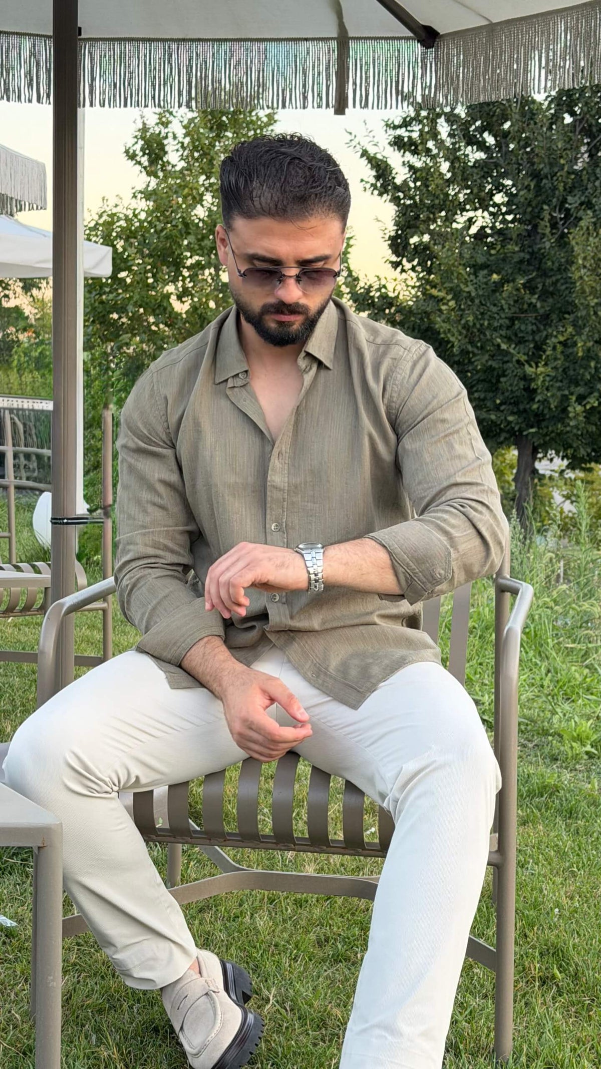 Men’s green textured cotton long sleeve casual shirt styled with white trousers for a smart casual outfit