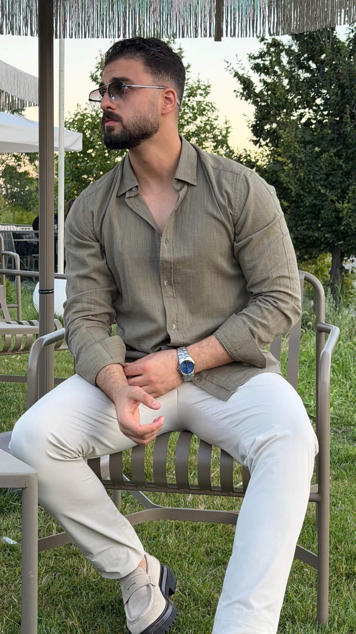 Men’s green textured cotton long sleeve casual shirt styled with white trousers for a smart casual outfit