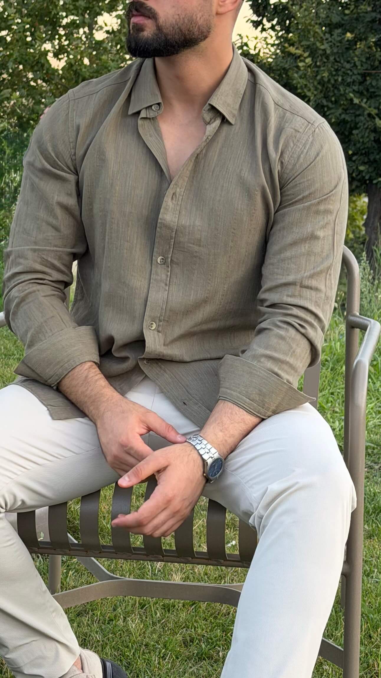 Men’s green textured cotton long sleeve casual shirt styled with white trousers for a smart casual outfit