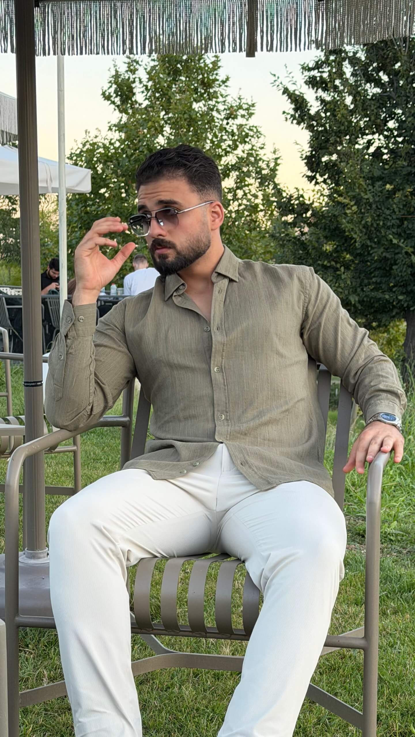 Men’s green textured cotton long sleeve casual shirt styled with white trousers for a smart casual outfit
