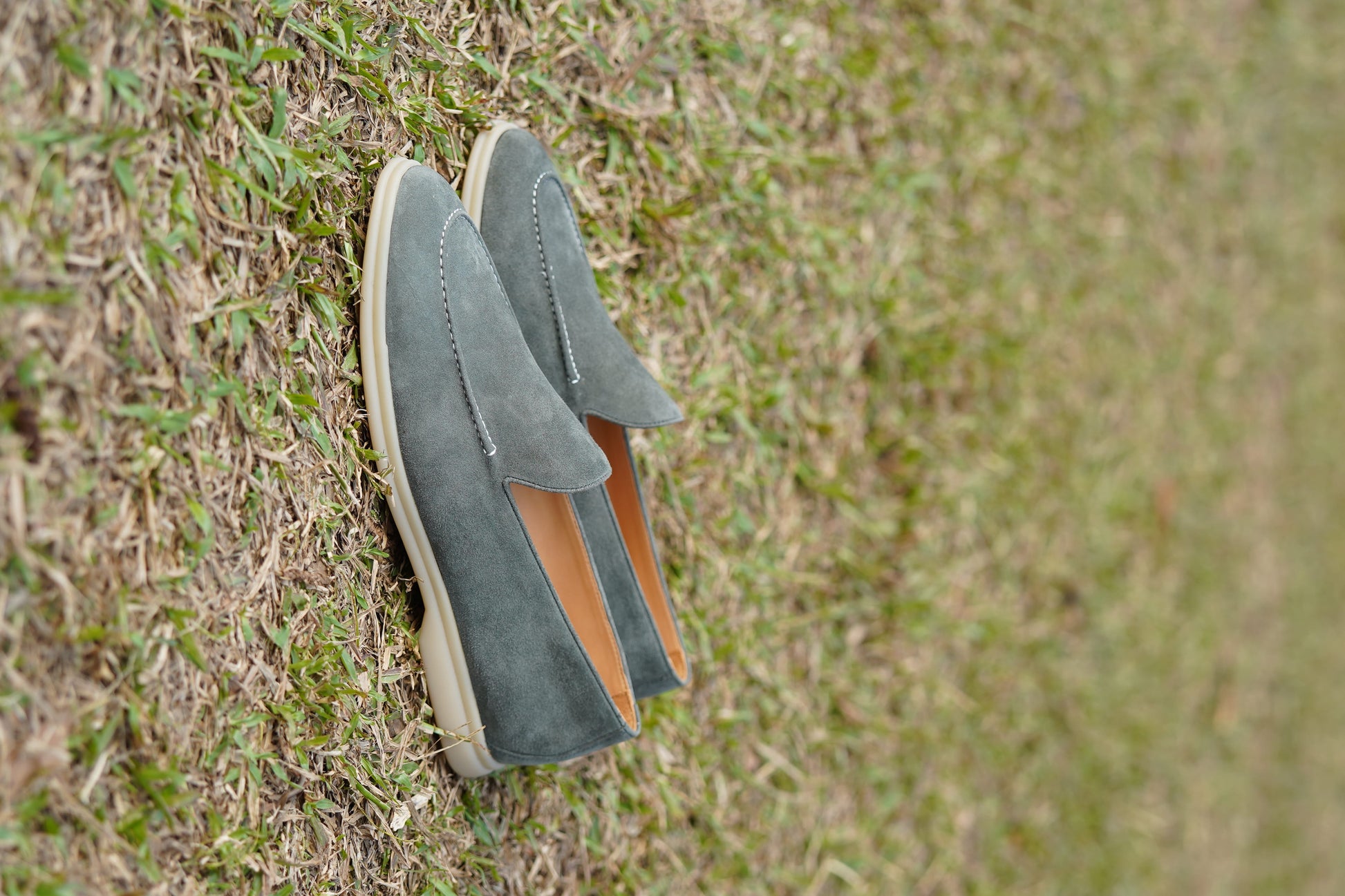 Men’s grey suede leather casual slip-on loafers with moccasin stitching and lightweight sole.