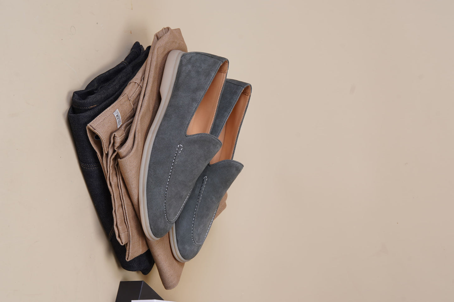 Men’s grey suede leather casual slip-on loafers with moccasin stitching and lightweight sole.