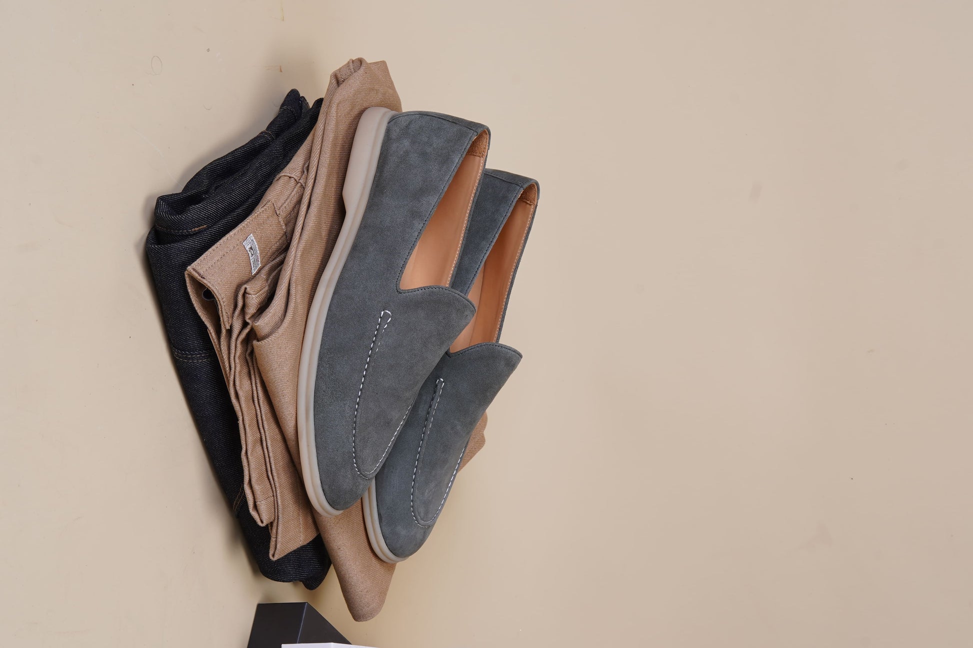 Men’s grey suede leather casual slip-on loafers with moccasin stitching and lightweight sole.