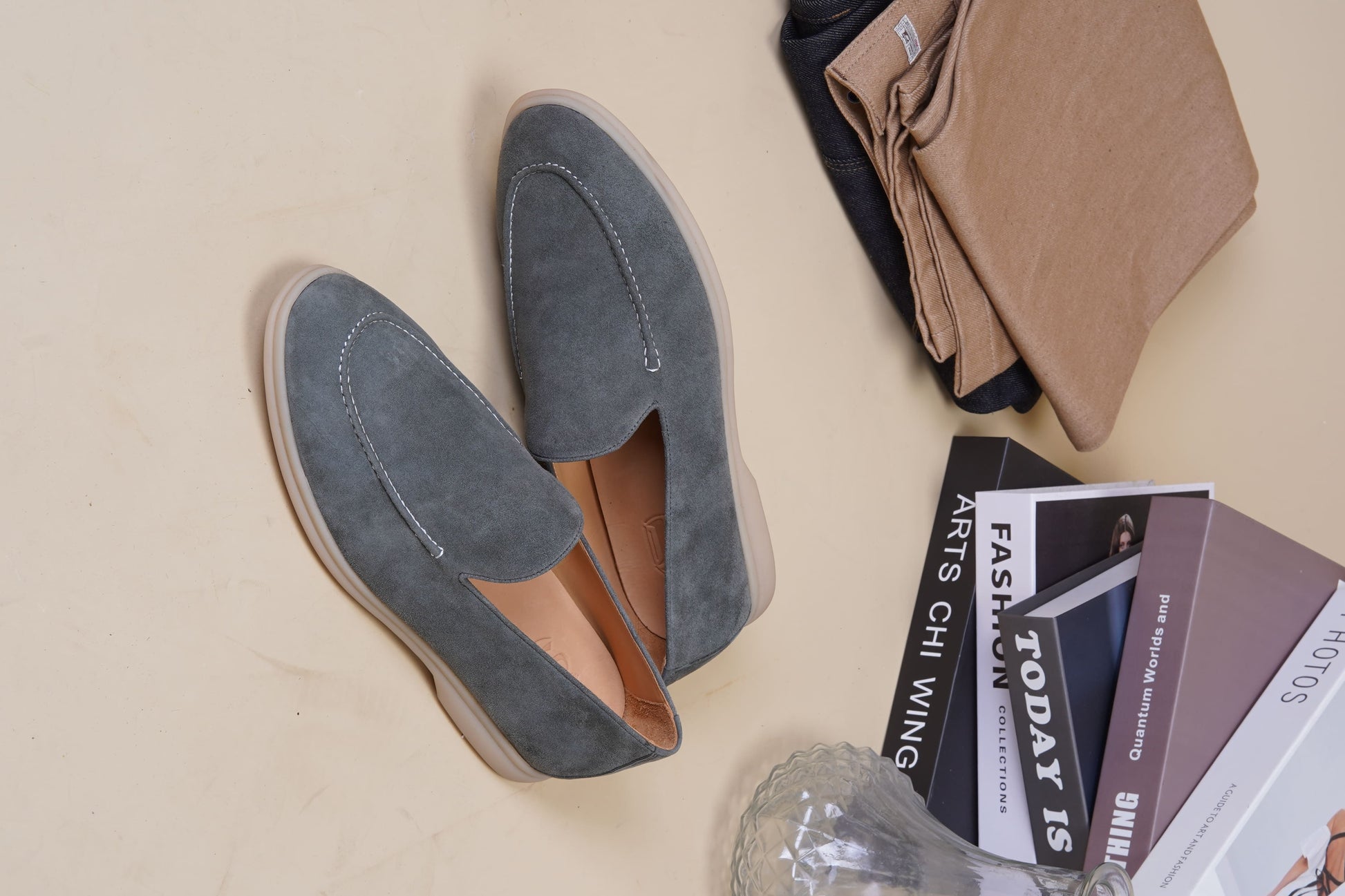Men’s grey suede leather casual slip-on loafers with moccasin stitching and lightweight sole.