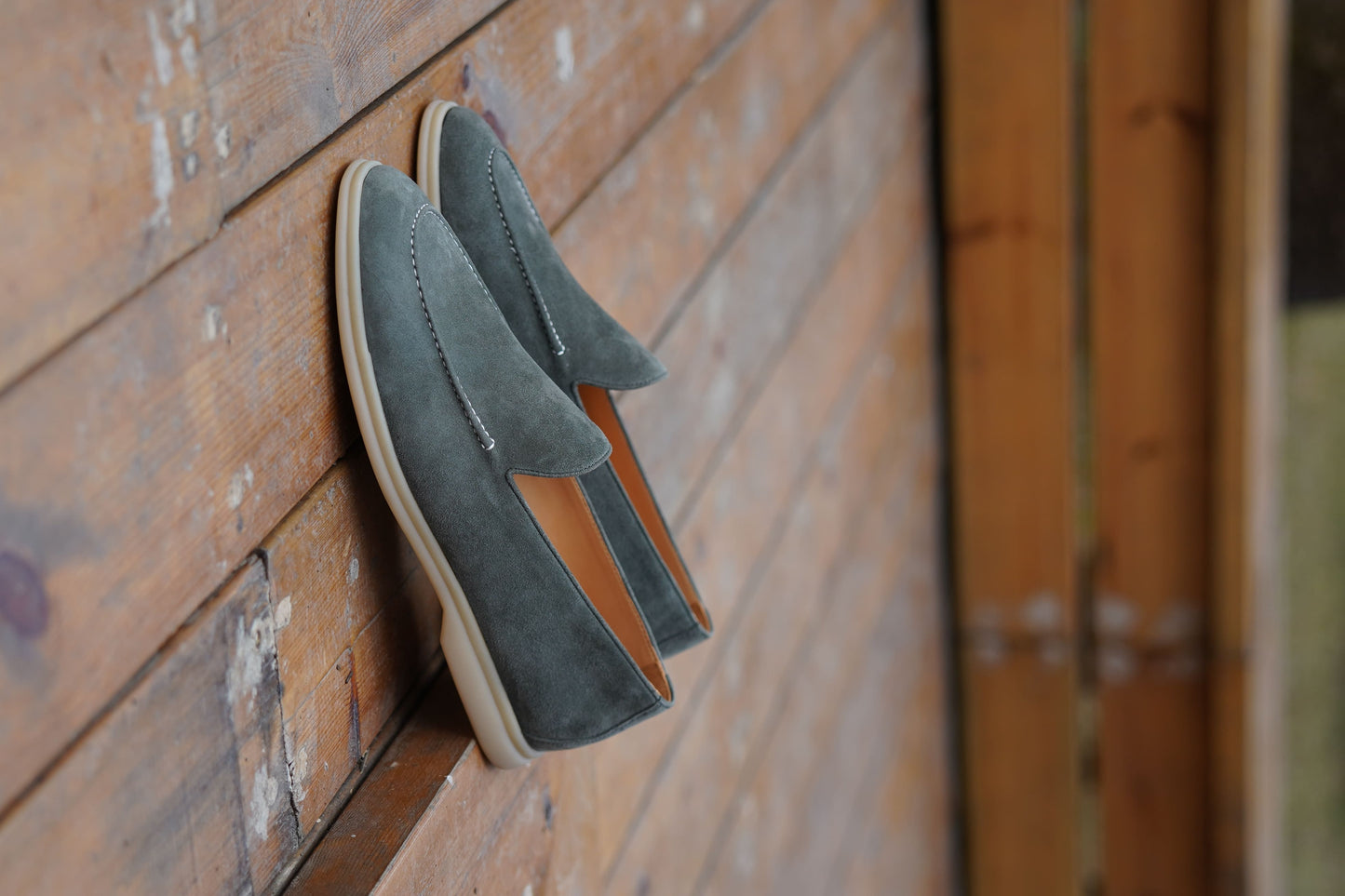 Men’s grey suede leather casual slip-on loafers with moccasin stitching and lightweight sole.