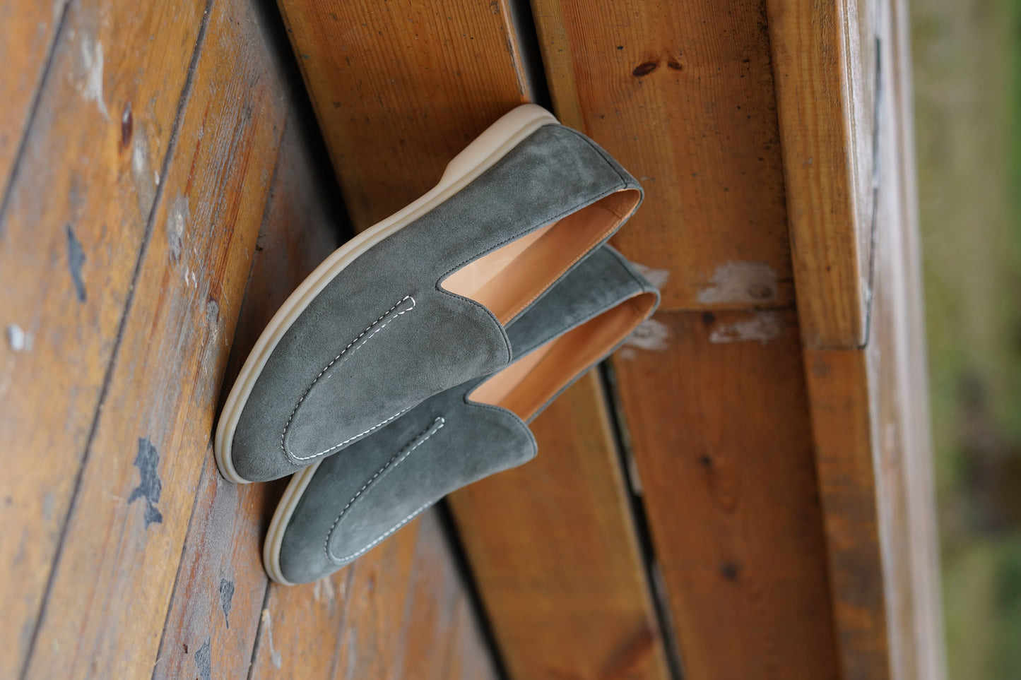 Men’s grey suede leather casual slip-on loafers with moccasin stitching and lightweight sole.