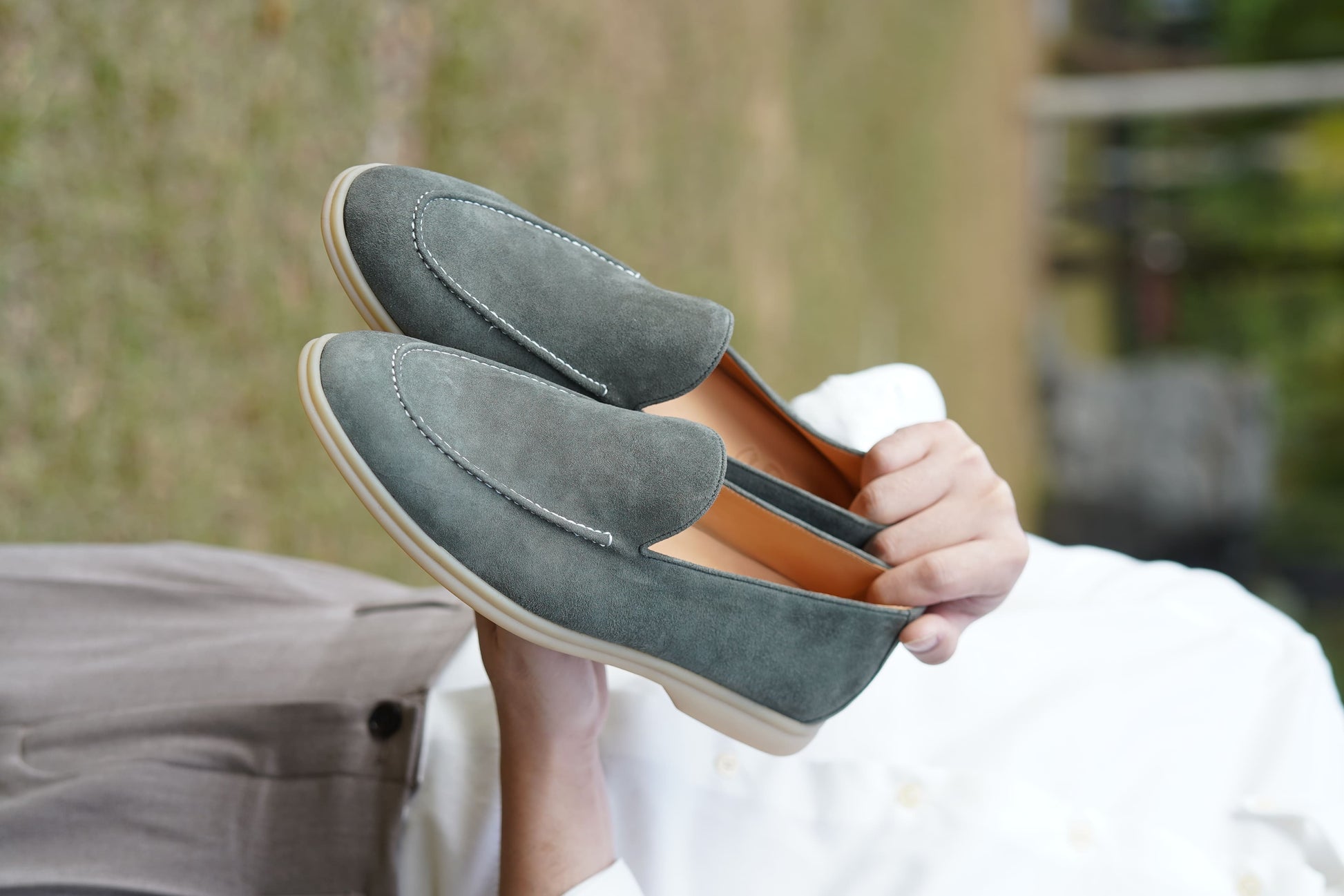 Men’s grey suede leather casual slip-on loafers with moccasin stitching and lightweight sole.