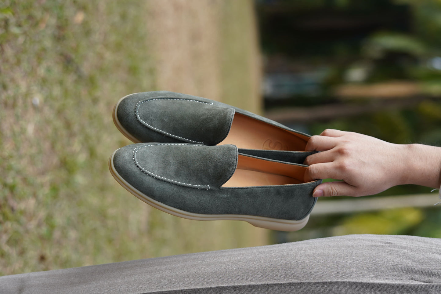 Men’s grey suede leather casual slip-on loafers with moccasin stitching and lightweight sole.