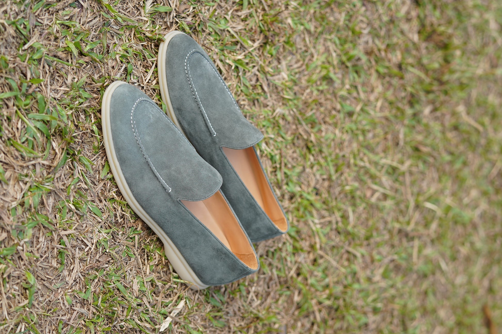Men’s grey suede leather casual slip-on loafers with moccasin stitching and lightweight sole.