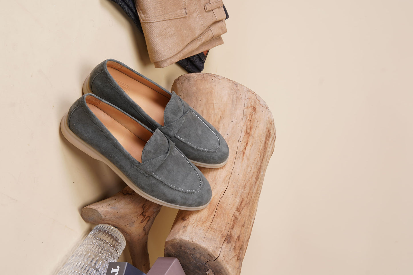 Men’s grey suede leather penny loafers featuring classic vamp strap detail and lightweight cream sole.
