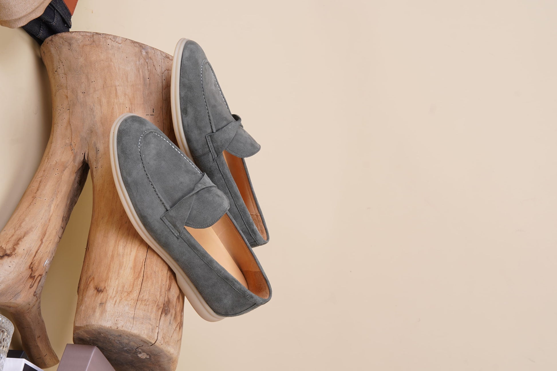 Men’s grey suede leather penny loafers featuring classic vamp strap detail and lightweight cream sole.