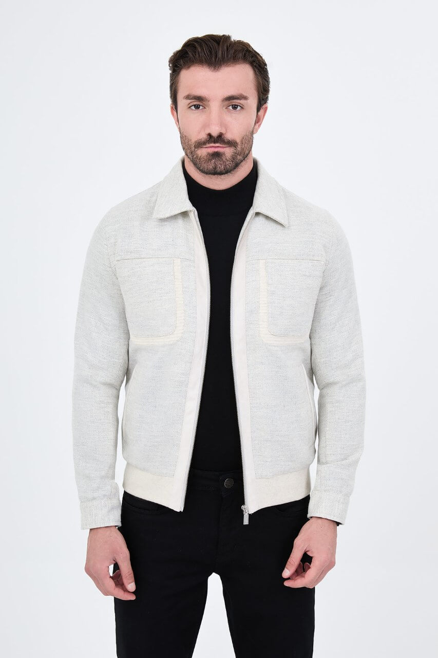 Light grey men's casual jacket styled with a black top and dark trousers.