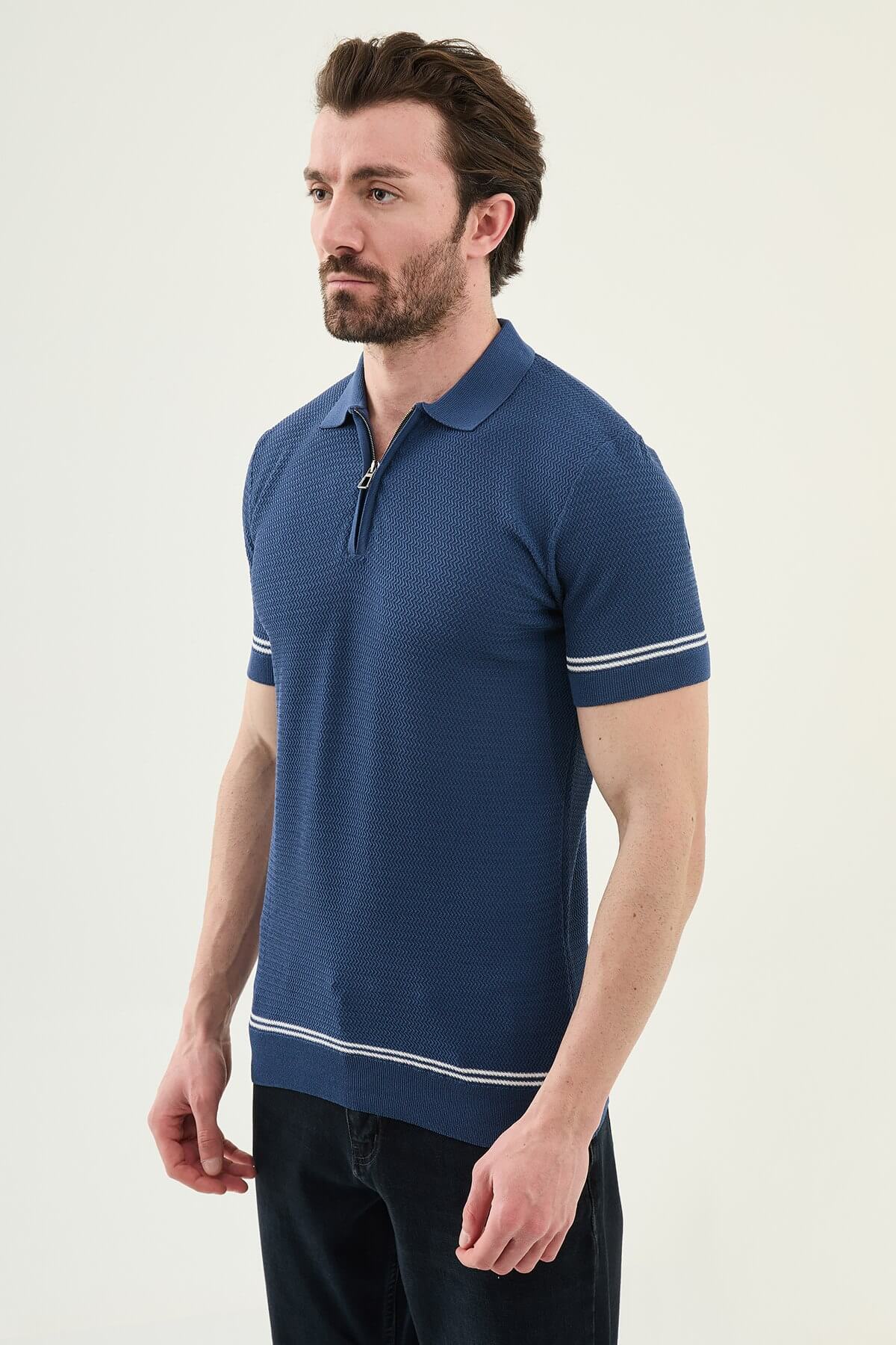 Male model wearing an indigo slim-fit quarter-zip polo T-shirt with short sleeves, styled for summer smart-casual outfits.