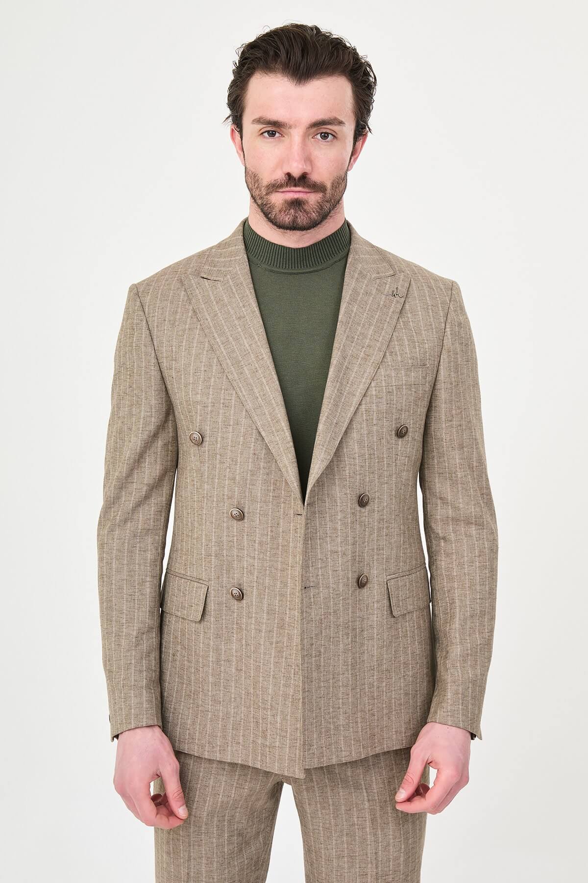 Men wearing a khaki pinstripe double-breasted slim-fit suit from the summer collection, styled with dress shoes and a green turtleneck