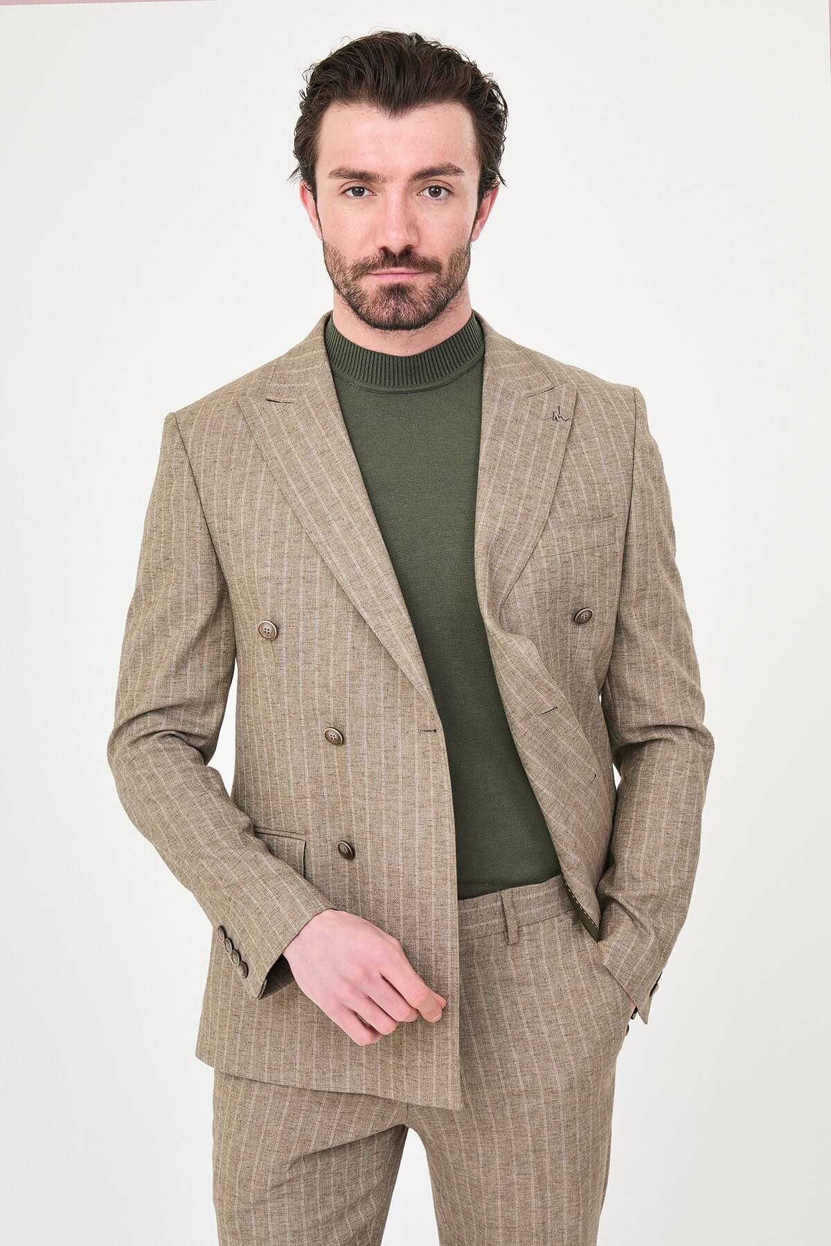 Men wearing a khaki pinstripe double-breasted slim-fit suit from the summer collection, styled with dress shoes and a green turtleneck