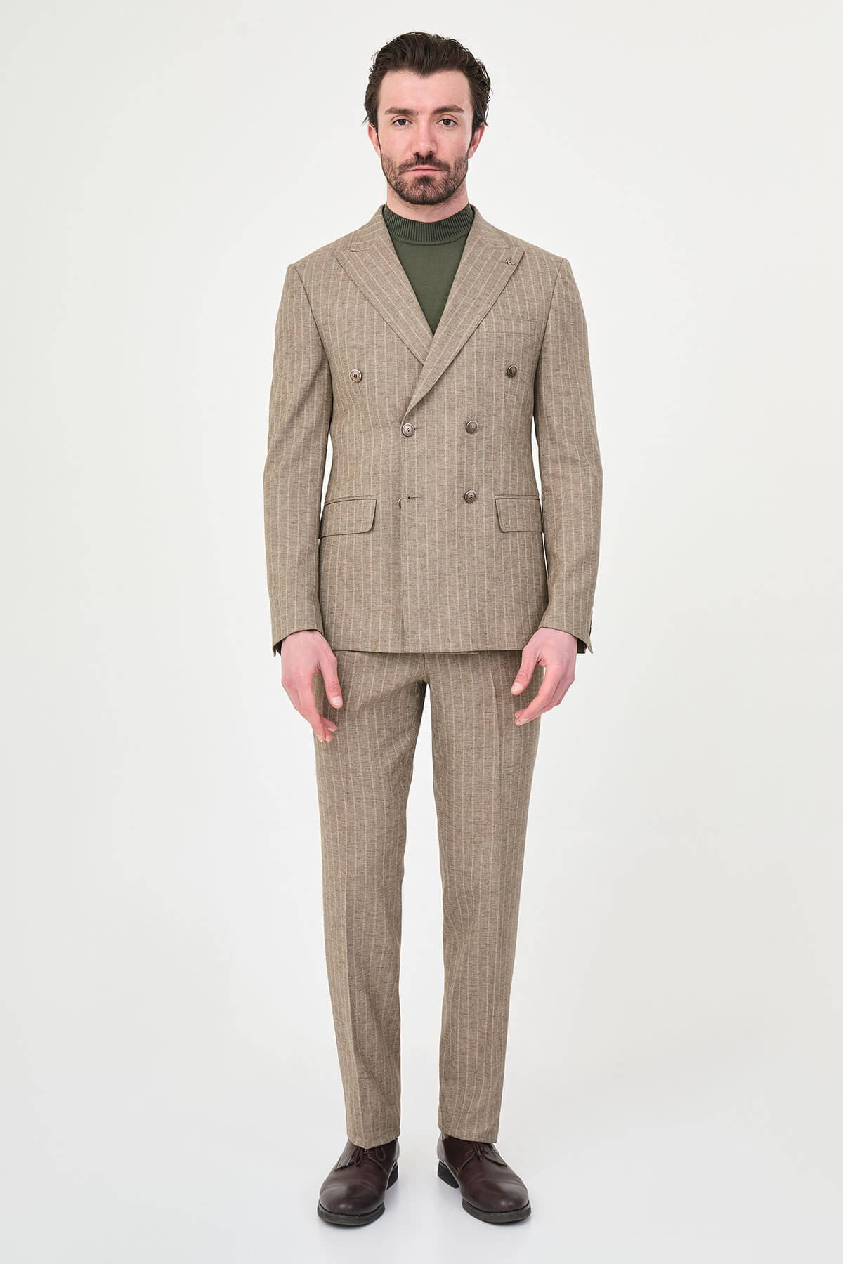Men wearing a khaki pinstripe double-breasted slim-fit suit from the summer collection, styled with dress shoes and a green turtleneck
