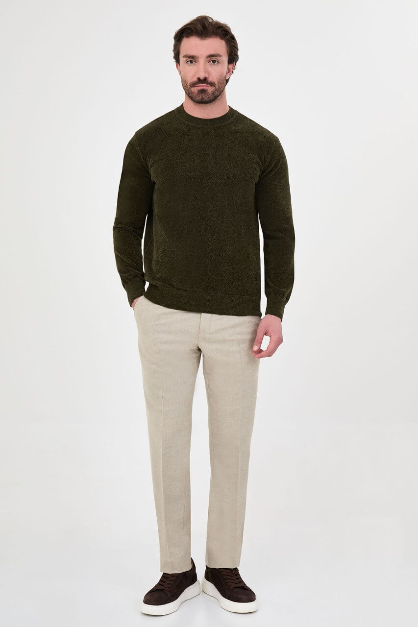 Men’s khaki crew neck knit sweater in a cotton blend slim fit design styled with neutral trousers for a refined fall winter outfit.