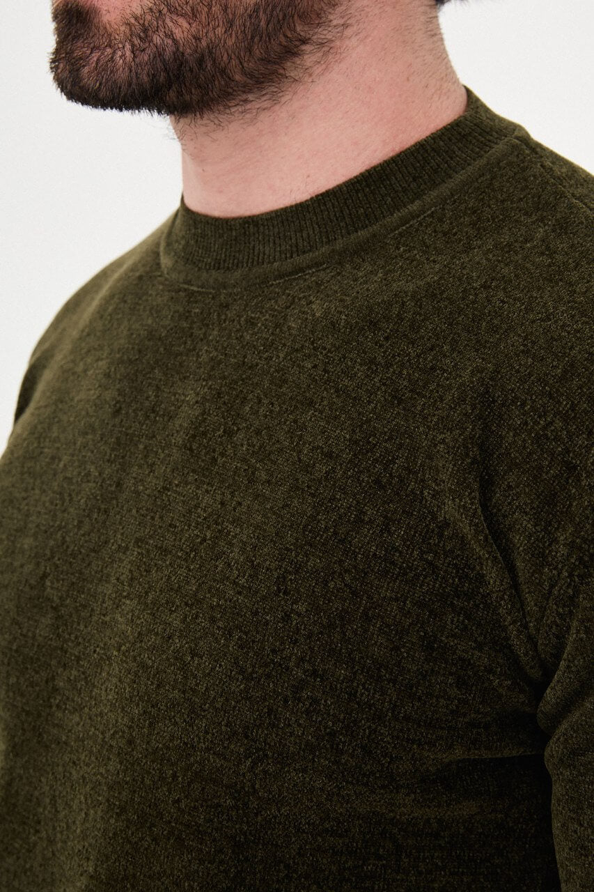 Men’s khaki crew neck knit sweater in a cotton blend slim fit design styled with neutral trousers for a refined fall winter outfit.