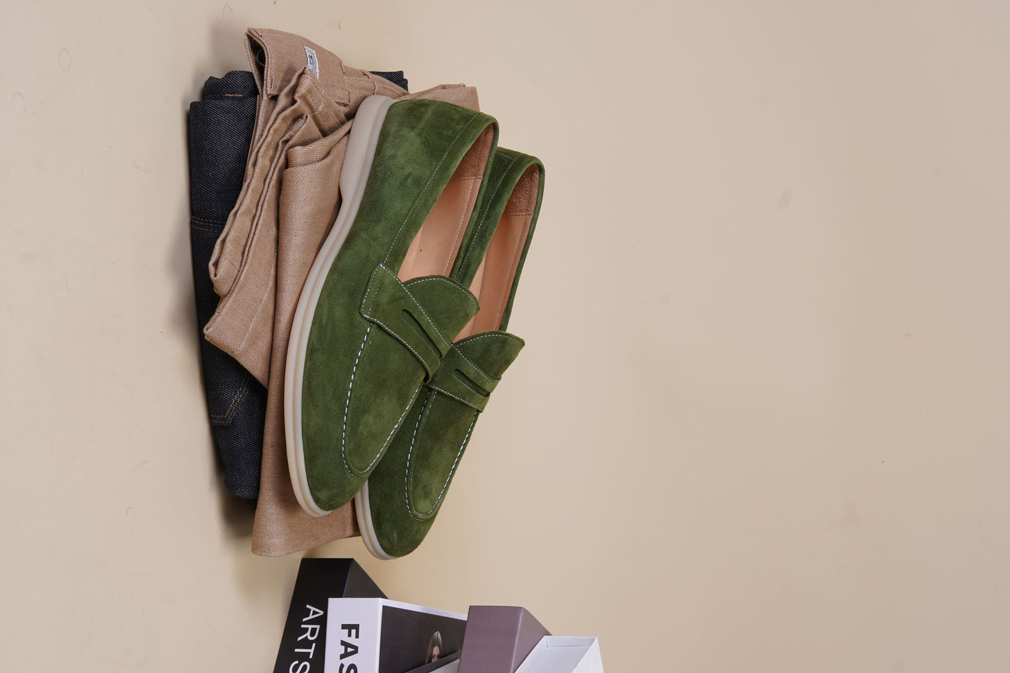 Men’s khaki green suede leather penny loafers with classic vamp strap detail and lightweight sole.