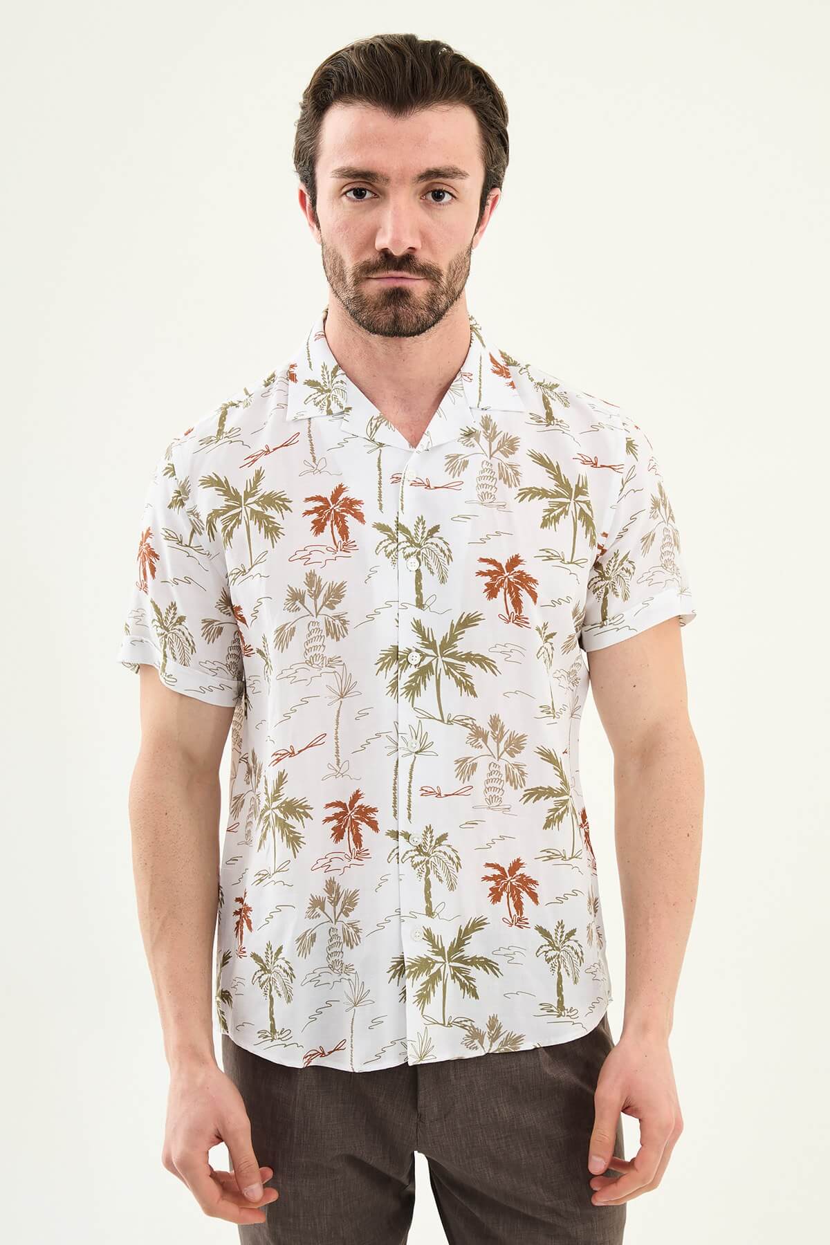 Men’s khaki palm tree print short sleeve shirt made from a lightweight Tencel and linen blend, styled for summer vacations and resort wear.