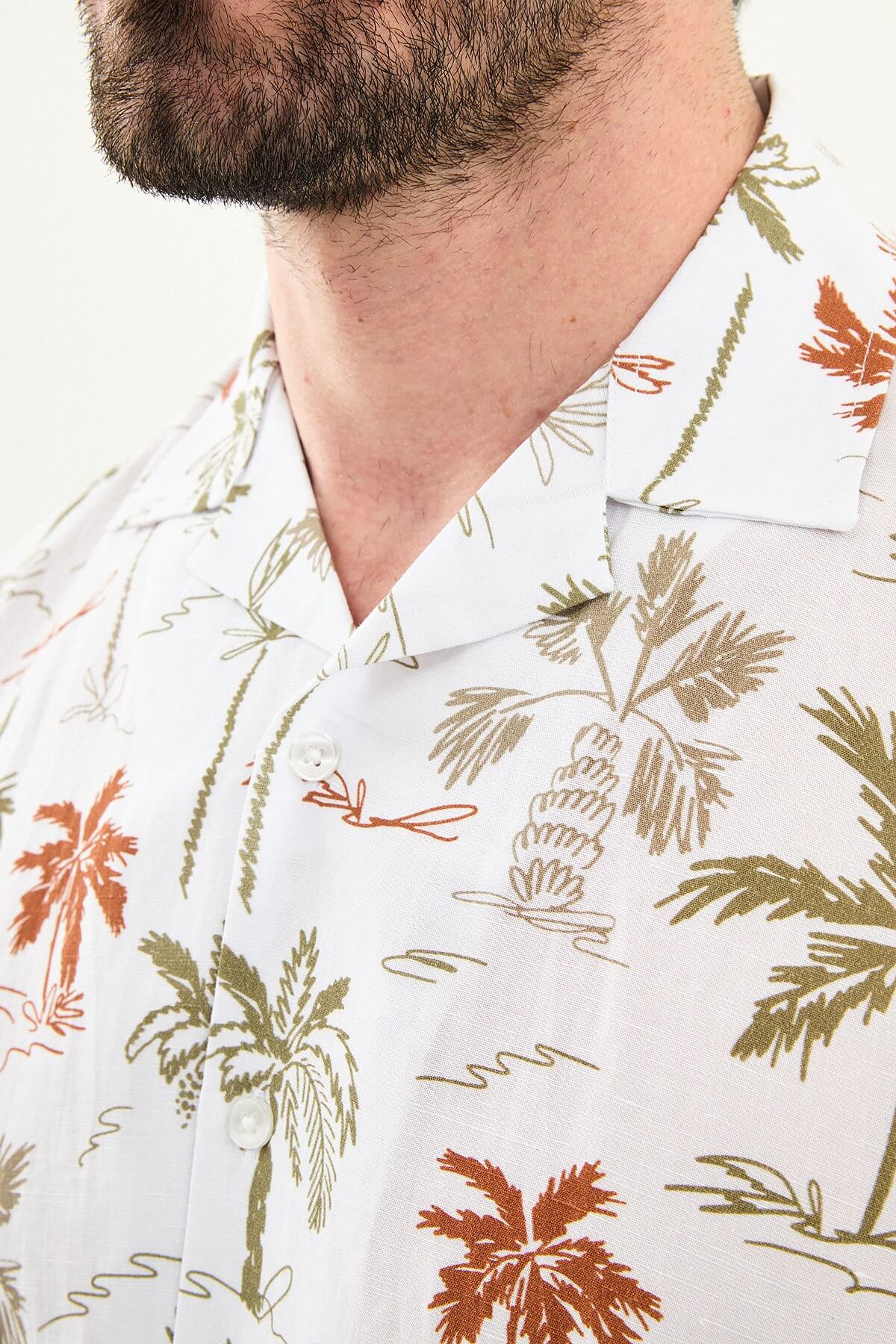 Men’s khaki palm tree print short sleeve shirt made from a lightweight Tencel and linen blend, styled for summer vacations and resort wear.