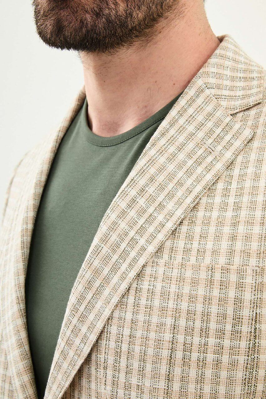 Men’s khaki slim fit cotton linen blazer with a lightweight textured pattern, styled for smart casual and elegant summer occasions.