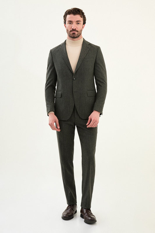 Men’s olive-toned khaki herringbone slim-fit single-breasted suit with structured shoulders and tailored waist, high-wool blend fabric with stretch for winter wear, styled with a cream fine-gauge turtleneck.