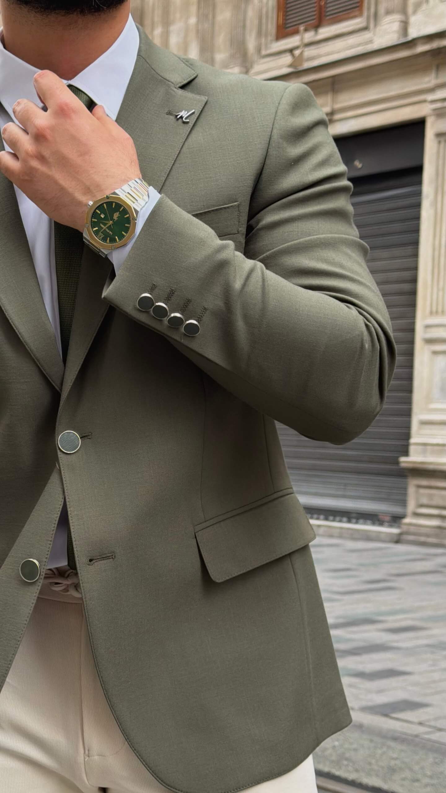 khaki textured blazer and matching trousers, styled with a white shirt and khaki shoes