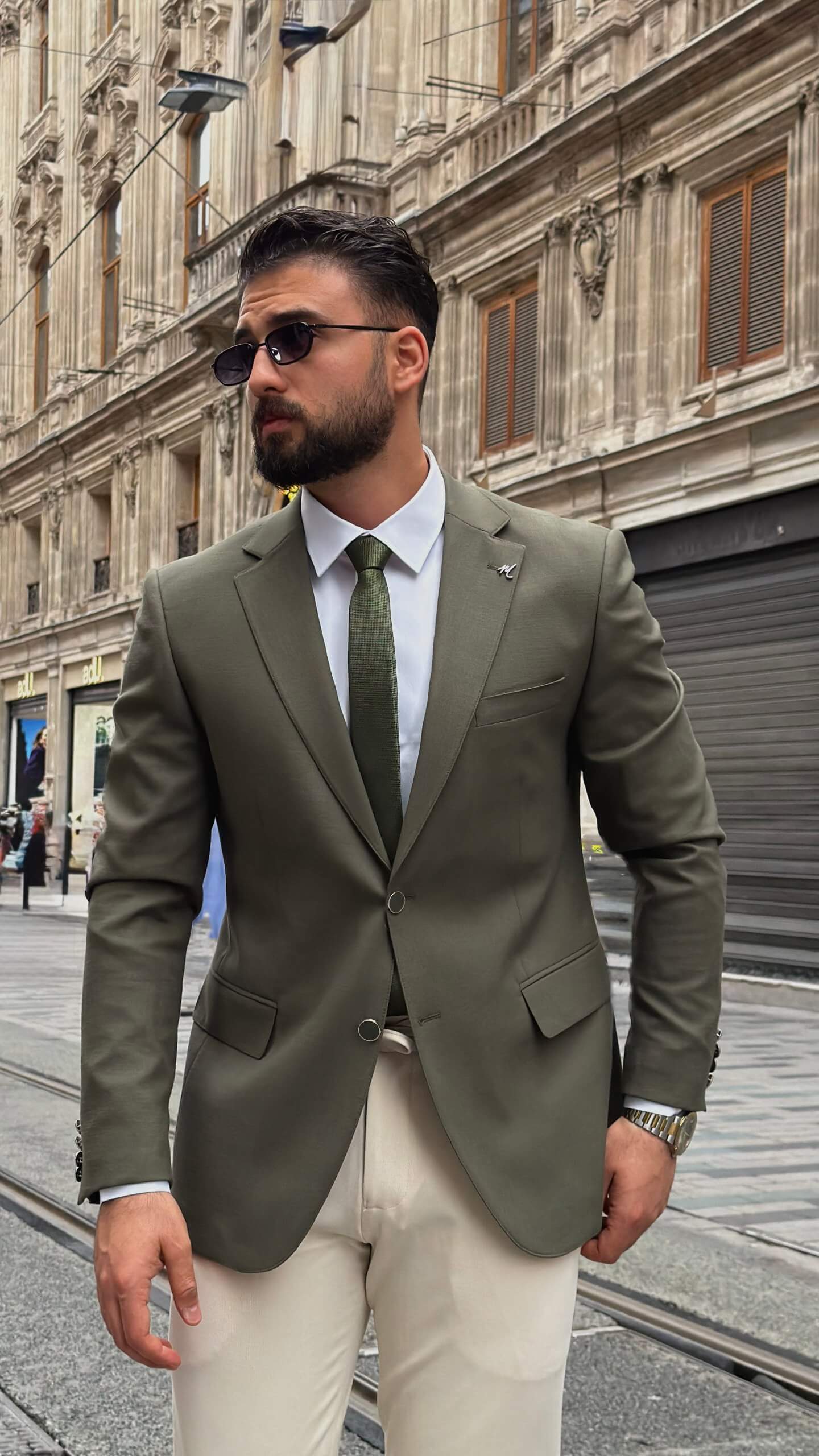 khaki textured blazer and matching trousers, styled with a white shirt and khaki shoes