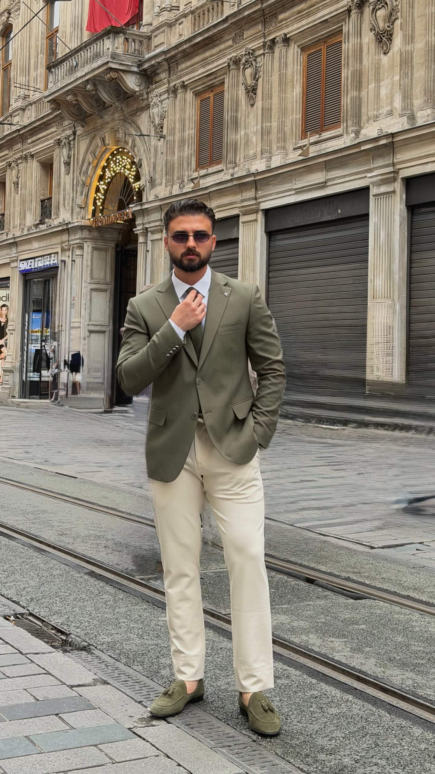 khaki textured blazer and matching trousers, styled with a white shirt and khaki shoes