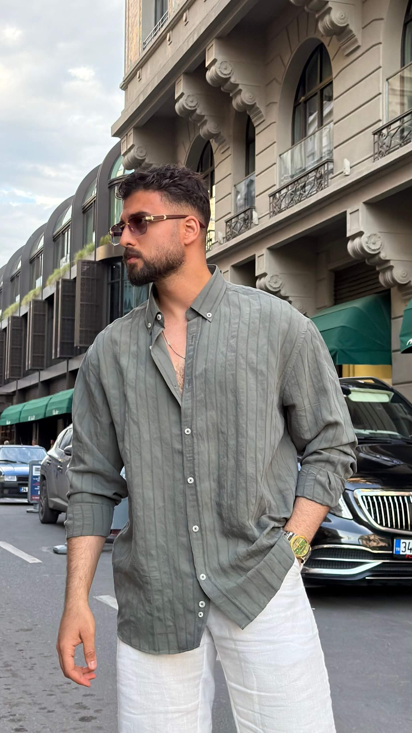 Khaki striped men's shirt styled for a summer smart casual outfit, back view
