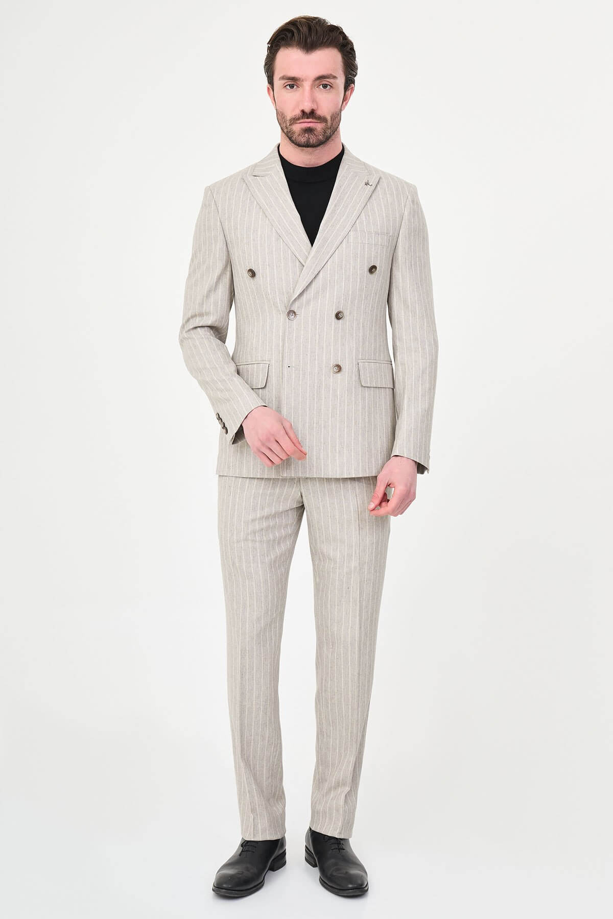 Light Beige Pinstripe Double-Breasted Suit worn by male model, slim fit, summer formalwear, front view, styled with black turtleneck and dress shoes.