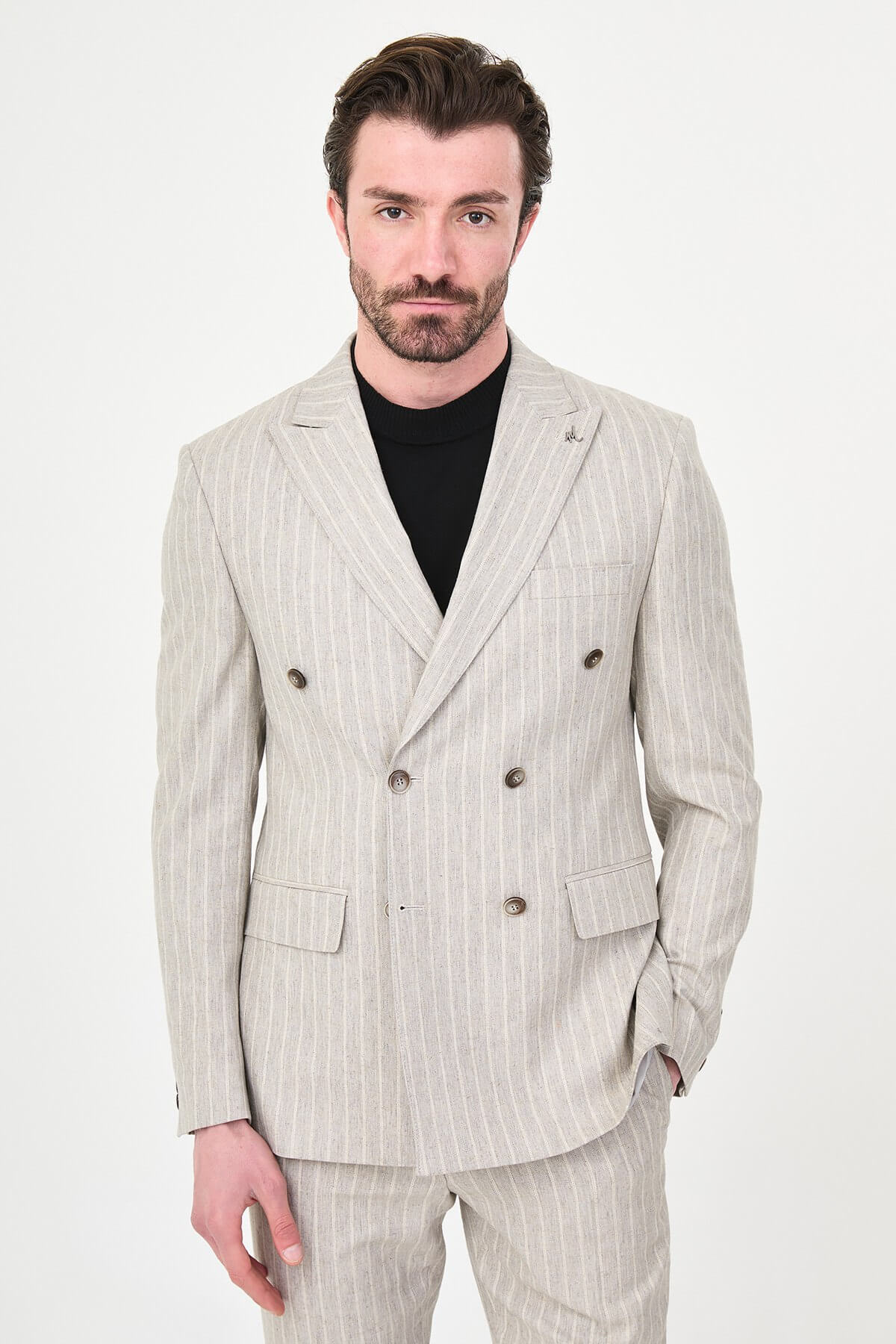 Light Beige Pinstripe Double-Breasted Suit worn by male model, slim fit, summer formalwear, front view, styled with black turtleneck and dress shoes.