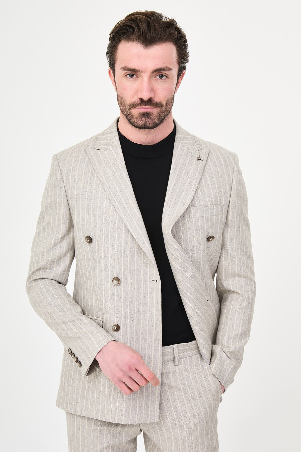 Light Beige Pinstripe Double-Breasted Suit worn by male model, slim fit, summer formalwear, front view, styled with black turtleneck and dress shoes.