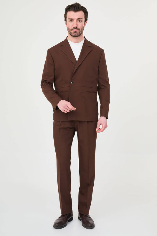 Men wearing a light brown slim fit suit with matching trousers, styled with a white crew-neck shirt, standing outdoors, showcasing a modern formal and smart-casual look.