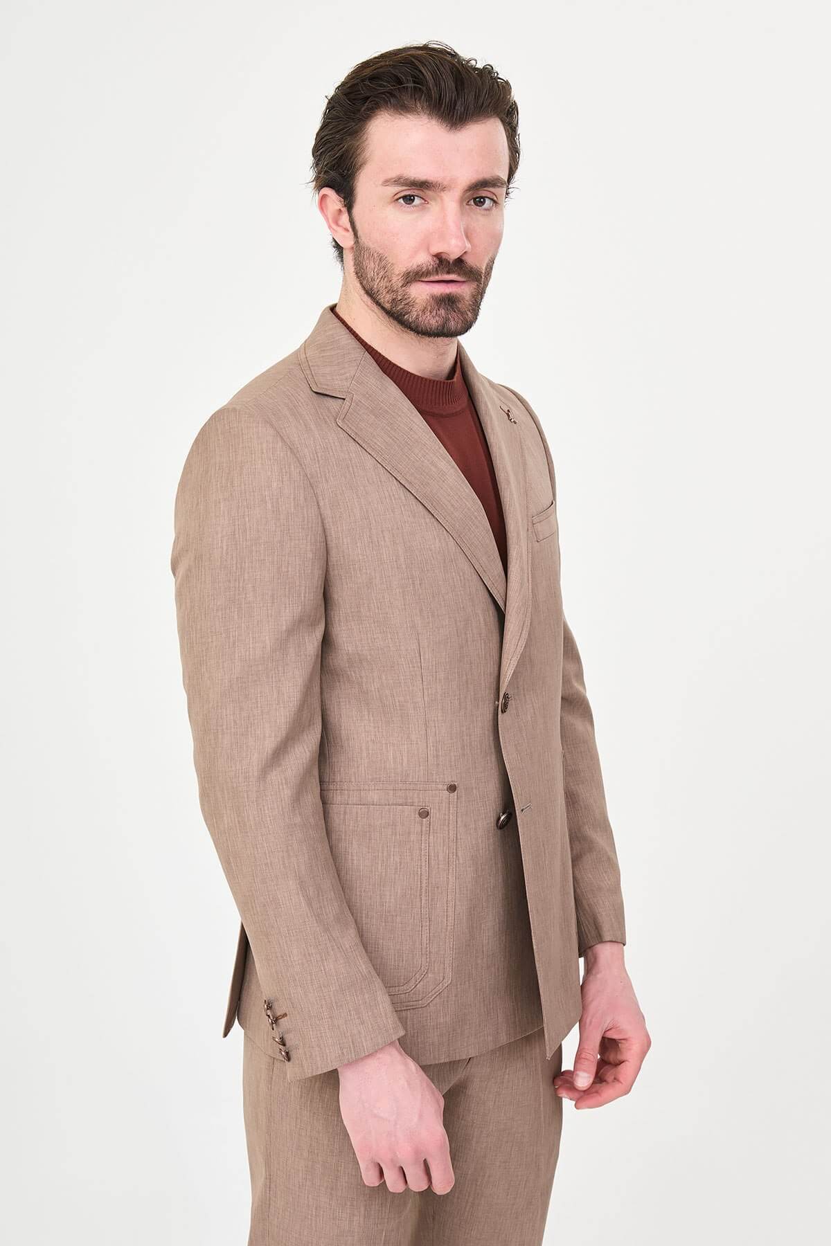 Model wearing a light brown slim-fit two-piece wedding suit with a white dress shirt, brown patterned tie, tailored trousers, and dark brown Derby shoes.