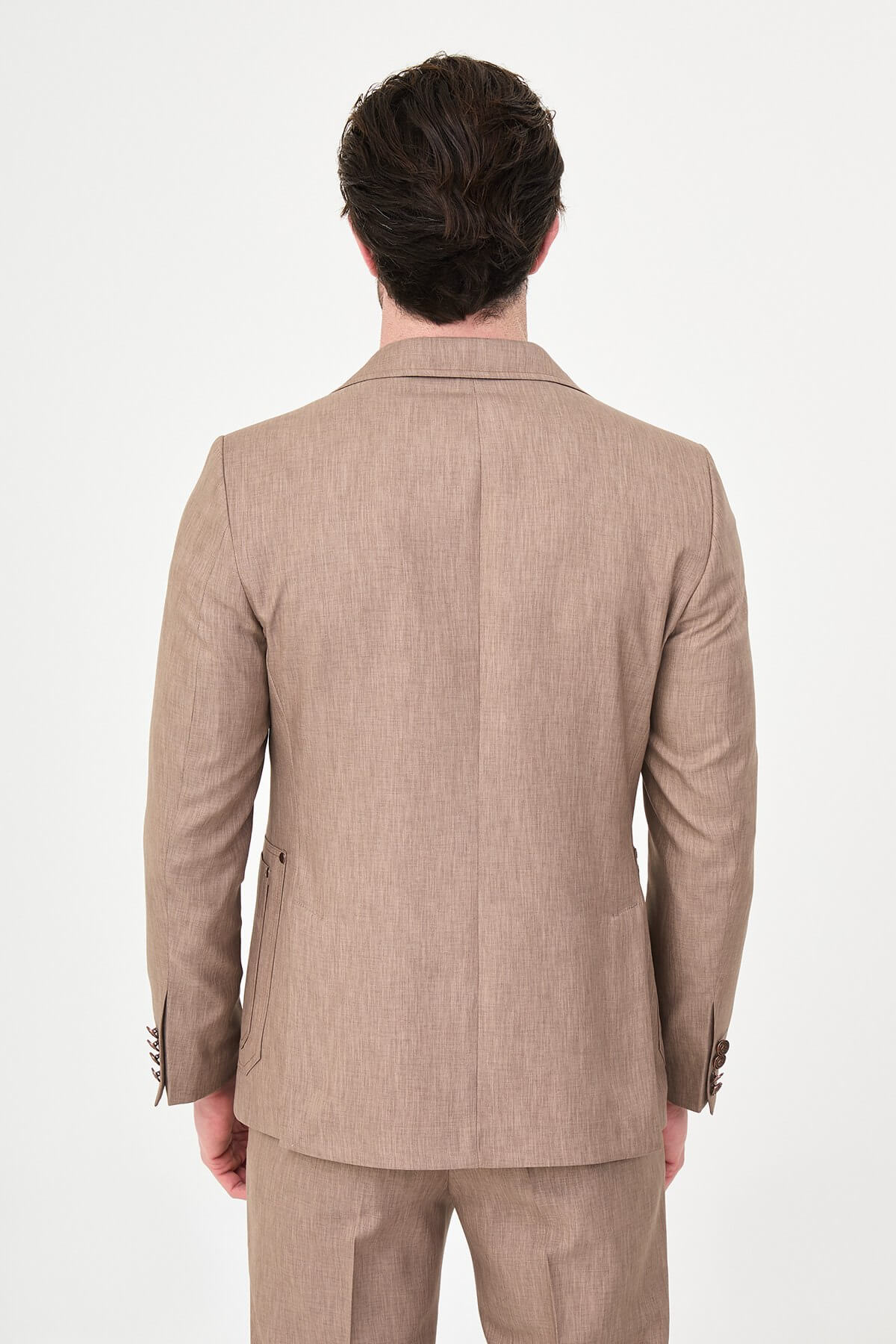 Model wearing a light brown slim-fit two-piece wedding suit with a white dress shirt, brown patterned tie, tailored trousers, and dark brown Derby shoes.