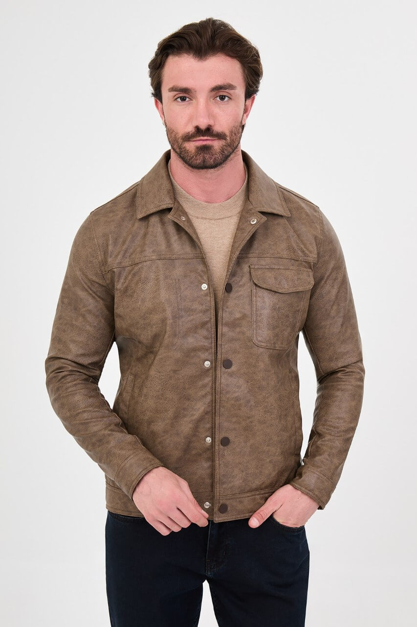 Men's mink-brown PU leather jacket styled with dark jeans, a beige sweater and brown boots.