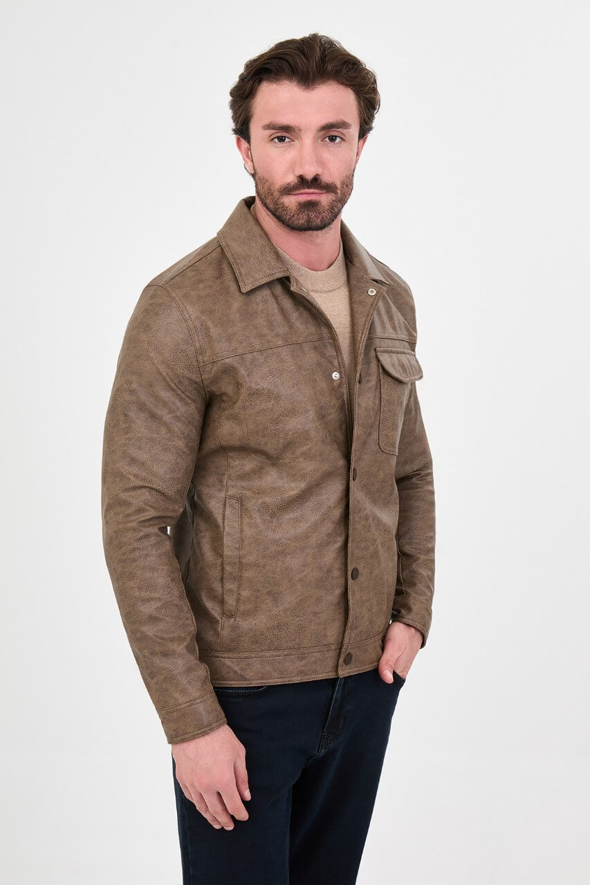 Men's mink-brown PU leather jacket styled with dark jeans, a beige sweater and brown boots.