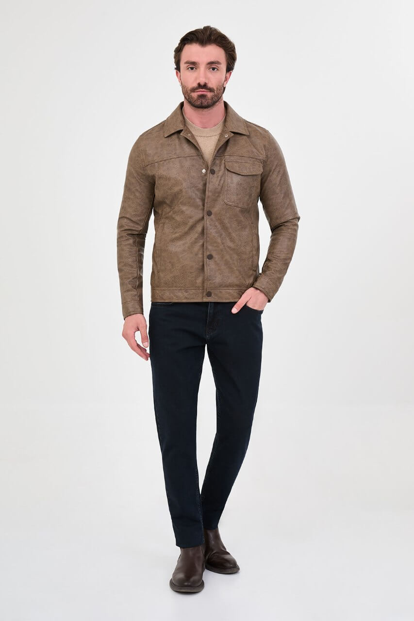 Men's mink-brown PU leather jacket styled with dark jeans, a beige sweater and brown boots.