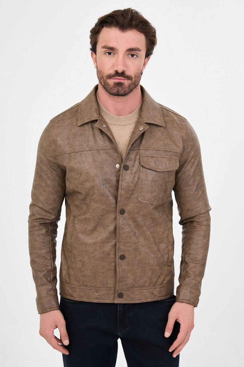 Men's mink-brown PU leather jacket styled with dark jeans, a beige sweater and brown boots.