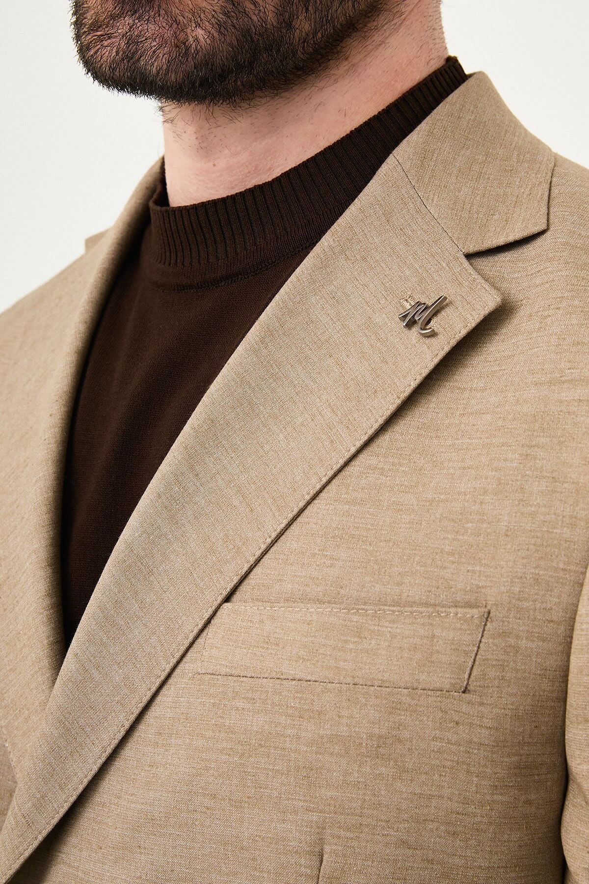 Mink slim fit pinstripe double-breasted summer suit, model wearing a fitted mink-colored suit with pinstripes, paired with dark dress shoes.