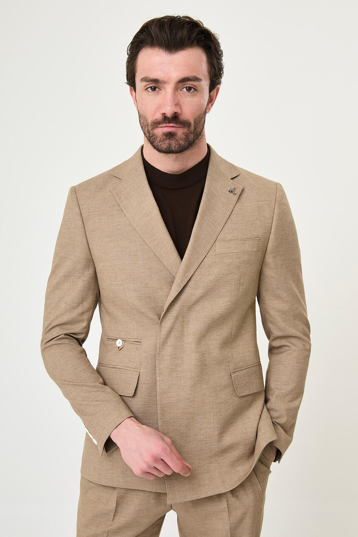Mink slim fit pinstripe double-breasted summer suit, model wearing a fitted mink-colored suit with pinstripes, paired with dark dress shoes.