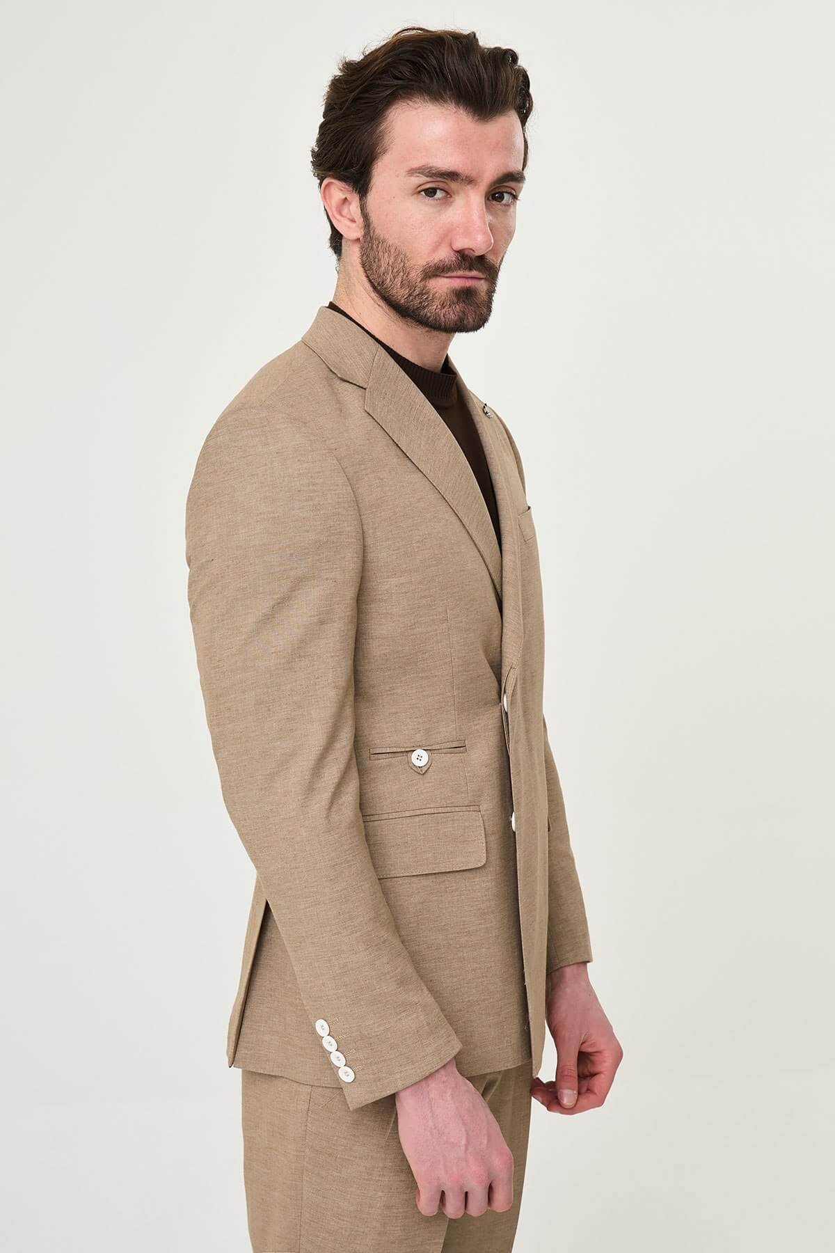 Mink slim fit pinstripe double-breasted summer suit, model wearing a fitted mink-colored suit with pinstripes, paired with dark dress shoes.