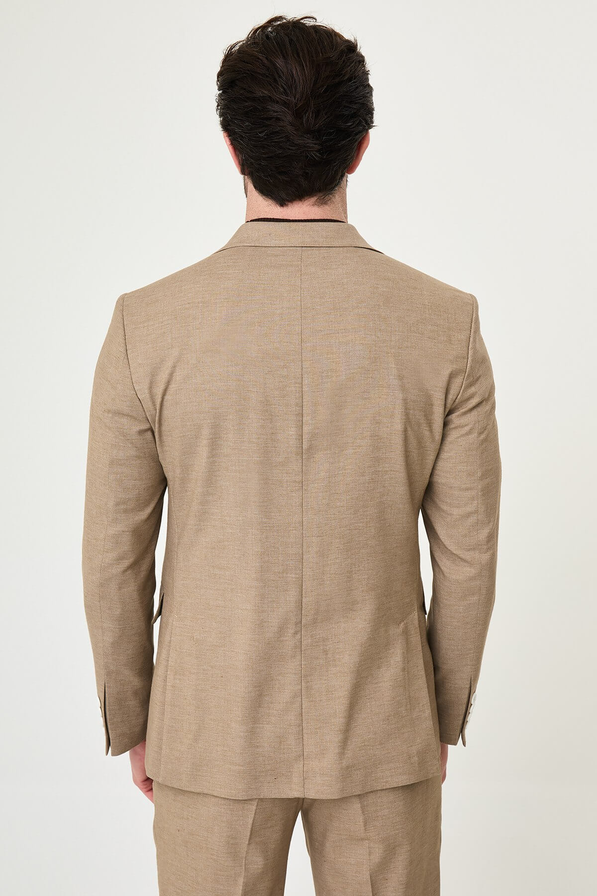 Mink slim fit pinstripe double-breasted summer suit, model wearing a fitted mink-colored suit with pinstripes, paired with dark dress shoes.