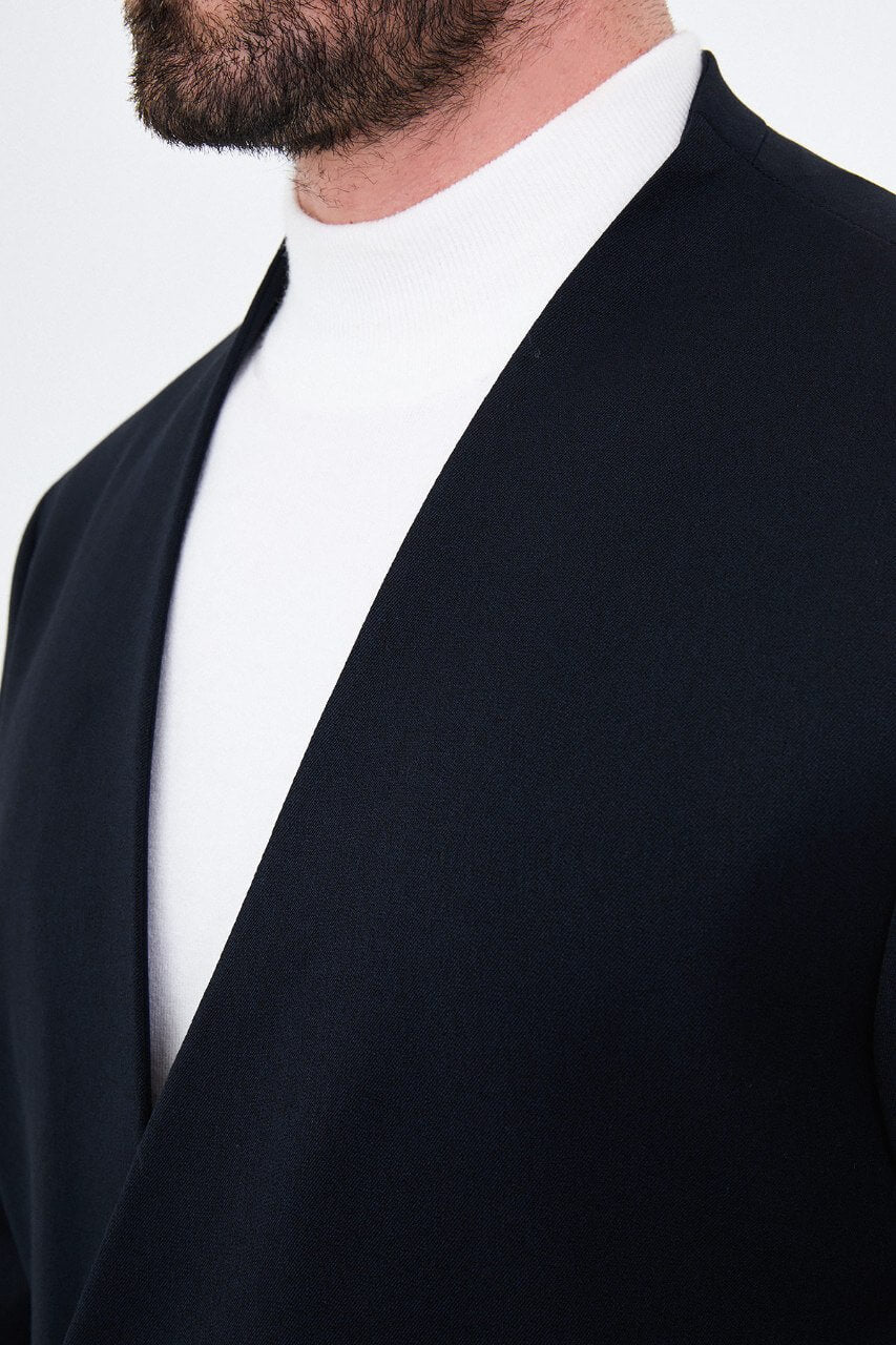 Men's navy blue slim-fit two-piece suit with a modern collarless V-neck jacket and matching trousers.